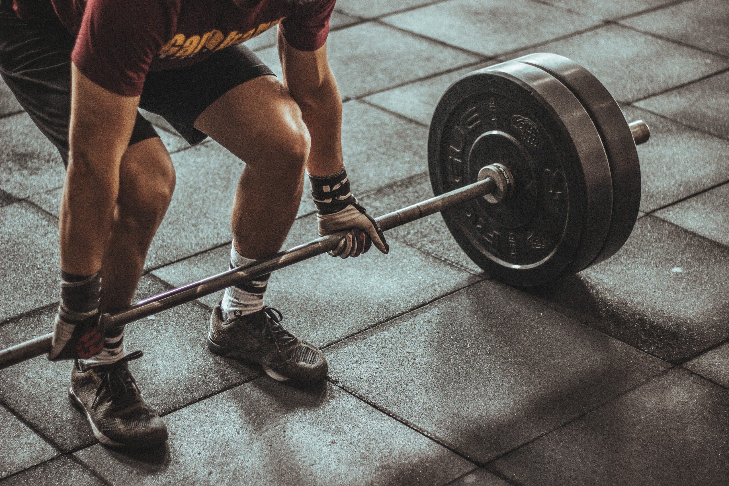 Close up shot of of a weight lifter and weights